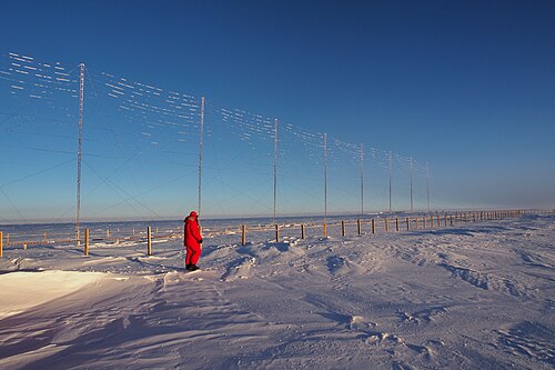 Inspecting the SuperDARN radar antenna installed at the Concordia research station, Antarctica (Paride Legovini).